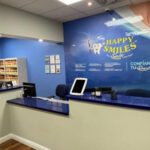 Happy Smiles Dental Clinic reception area with friendly staff ready to assist patients.